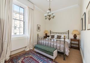a bedroom with a bed and a window at Parliament Sq (apt 10 ) Royal Mile in Edinburgh