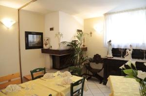 a dining room with a table and a fireplace at Hotel Ristorante Vittoria in San Fedele Intelvi