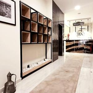 a room with a large glass wall with a shelf at Hotel DOA in Skopje