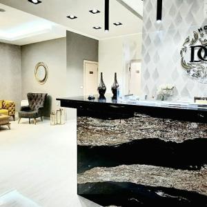 a living room with a black counter with a rug at Hotel DOA in Skopje