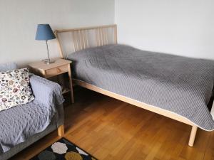 a bedroom with two beds and a night stand with a lamp at Apartment with sauna near the Saimaa lake in Lappeenranta