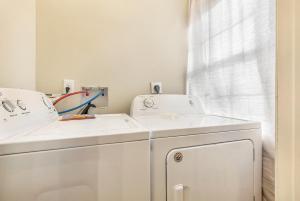 - une buanderie avec deux lavabos et un lave-linge/sèche-linge dans l'établissement St Charles Spacious Condo in the Heart of the City, à La Nouvelle-Orléans