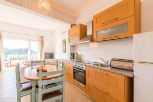 A kitchen or kitchenette at Lakka Seaview Apartments by Konnect