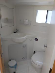 a white bathroom with a toilet and a sink at Rendez Vous Fantasia in Chioggia