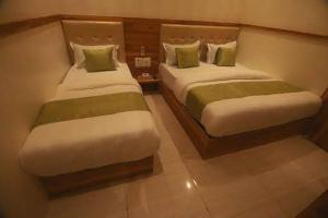 Postel nebo postele na pokoji v ubytování Hotel Al Madina palace
