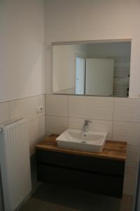 a bathroom with a sink and a mirror at Glück Auf Rügen in Ostseebad Sellin