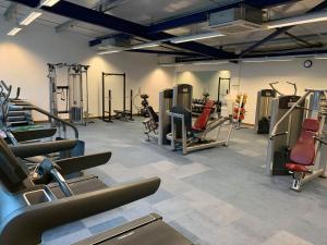 a gym with treadmills and machines in a room at Lakeside Lodge in Pidley