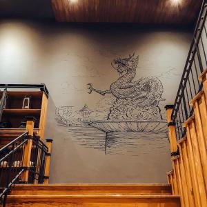 a mural of a rooster on a wall at Aurico Kata Resort & Spa - SHA Extra Plus in Kata Beach