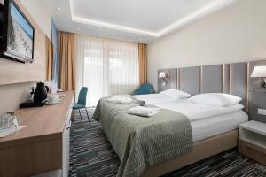 Postel nebo postele na pokoji v ubytování Hotel Dom Zdrojowy Resort & SPA - Destigo Hotels