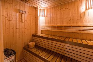 an empty wooden sauna with a trash can in it at Aurico Kata Resort & Spa - SHA Extra Plus in Kata Beach