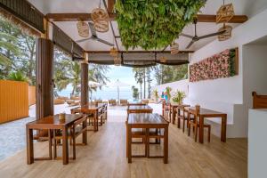 a restaurant with tables and chairs and a view of the ocean at Resto Sea Resort - Baan Krut in Prachuap Khiri Khan