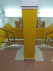 a yellow pole in the middle of a building at Hotel Abby IGB Tasek in Ipoh