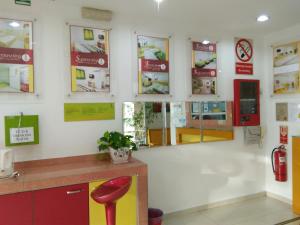 a waiting room at a pharmacy with a red stool at Hotel Abby IGB Tasek in Ipoh