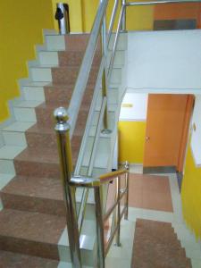 a staircase with a glass railing in a building at Hotel Abby IGB Tasek in Ipoh