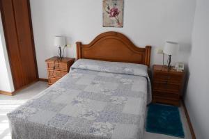 a bedroom with a bed and two night stands at Hotel Restaurante Xaneiro in Melide