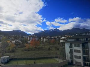 a tennis court in a city with mountains in the background at Royal Bansko - Half Board Plus & All Inclusive - Hot Pool & Jacuzzis in Bansko