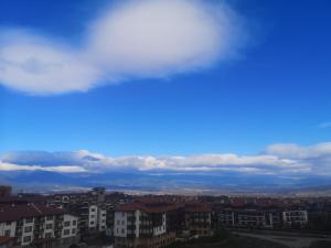 a view of a city with a cloudy sky at Royal Bansko - Half Board Plus & All Inclusive - Hot Pool & Jacuzzis in Bansko