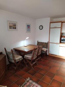 a kitchen with a table and chairs in a room at Haus Annette in Weisweil