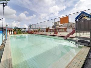 a swimming pool with a slide on top of a building at Villa Puncak Agape near Cipanas Mitra RedDoorz in Cianjur