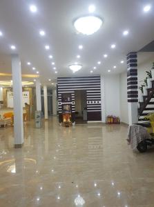 a large living room with a stove and a staircase at Nice Hotel Buôn Ma Thuột in Buon Ma Thuot