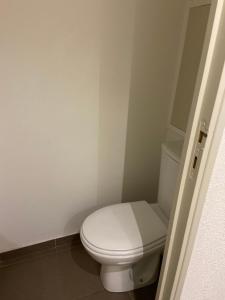 a bathroom with a white toilet in a room at Appartement Les Menuires in Les Menuires