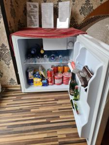 an open refrigerator filled with food and drinks at VILA VALENCIA in Azuga
