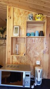 a kitchen with a microwave and a counter top at Chalet des Mésanges in Annonay