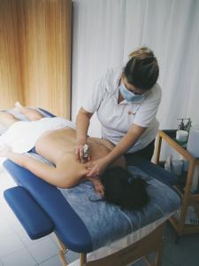 a woman in a hospital room getting a stomach massage at Impact House Belém in Lisbon