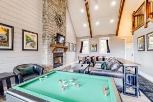 a living room with a pool table and a fireplace at Mountain View Memories in Gatlinburg