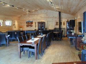 a dining room with wooden tables and chairs at Camp Uvdal in Uvdal