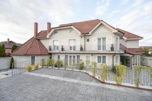 a house with a large driveway in front of it at Dozsa Residence in Oradea