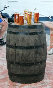 a group of glasses of beer sitting on a barrel at The Blue Bell in Midhurst