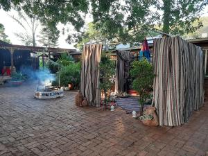 a patio with a group of umbrellas and plants at Wooden Creek Estate in Kempton Park