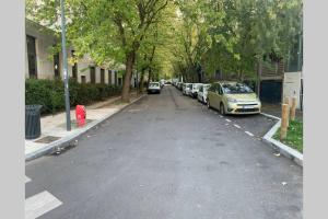 a parking lot with cars parked on the side of a street at La Belle Étoile in Noisy-le-Grand