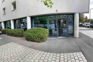 a building with a revolving door in front of it at La Belle Étoile in Noisy-le-Grand