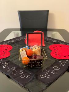 a cake with a basket of fruit on a table at Flat 18 in Dumfries