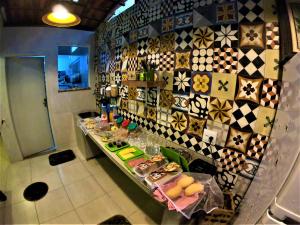 a kitchen with a counter with food on it at Mata Virgem Hostel e Pousada in Abraão