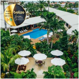 an overhead view of a resort with a pool and umbrellas at Best Western Plus Belize Biltmore Plaza in Belize City