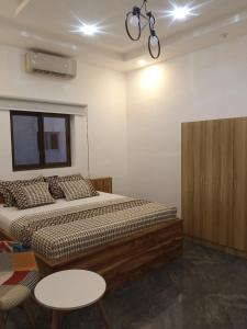 - une chambre avec un lit, une table et une armoire dans l'établissement Marys Guest House, à Lomé