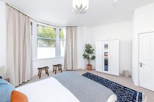 a bedroom with a bed and a large window at Stunning Apartment In Peaceful Central Neighbourhood, Free Private Parking in Cardiff
