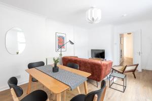 a living room with a table and a couch at Stunning Apartment In Peaceful Central Neighbourhood, Free Private Parking in Cardiff