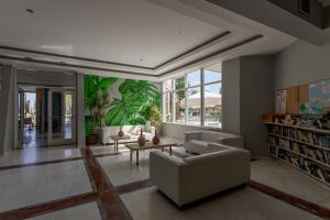 a living room with a couch and a table at Georgioupolis Beach Hotel in Georgioupolis