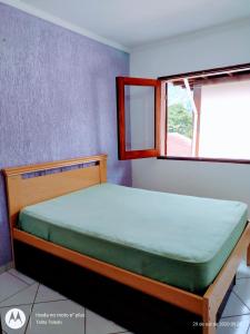 A bed or beds in a room at Recanto Canoa Pequena