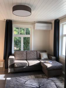 a living room with a couch and a window at Villa Taivaanvuohi in Kyrö +50 photos