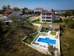 an aerial view of a house with a swimming pool at B&M Rab-Lopar in Lopar