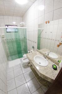 uma casa de banho com um lavatório e um WC em Pousada Rota do Sol em Penha