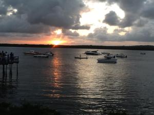 a group of boats on the water at sunset at Sereia de Carapibus in Jacumã +5 photos