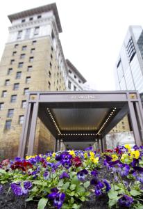 a flower arrangement in front of a tall building at The Saint Paul Hotel in Saint Paul