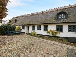 a large white building with a thatched roof at 2 person holiday home in Gilleleje in Gilleleje