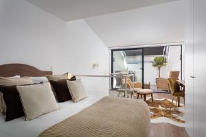 a bedroom with a bed and a living room at STUPENDO-Three Rooms-Suite with Terrace -Center -Air conditioning in Lisbon